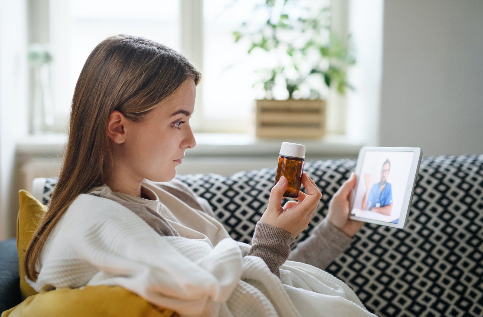 young-woman-having-video-call-with-doctor-on-tablet-at-home-online-consultation-concept-.jpg